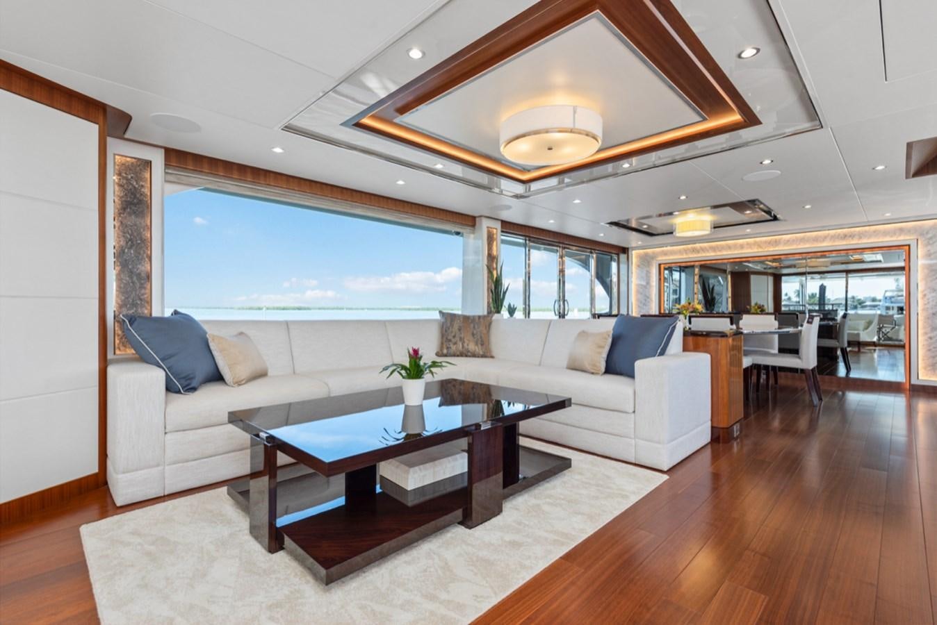 a living room with a large open window aboard EVERGLADE Yacht for Sale