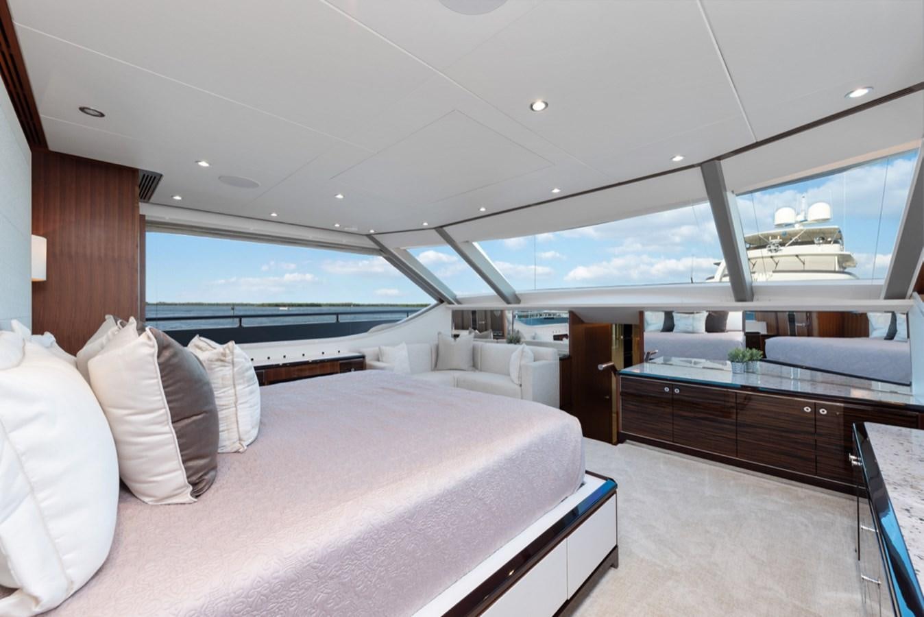 a room with a large bed and a large window aboard EVERGLADE Yacht for Sale