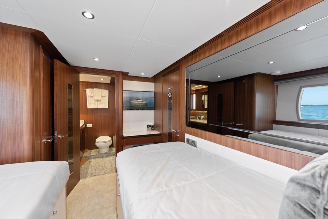 a large bedroom with a large bed aboard EVERGLADE Yacht for Sale