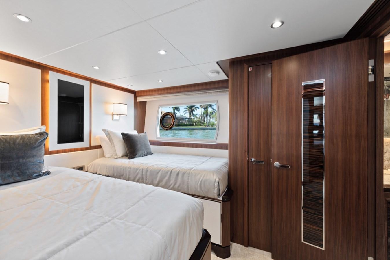 a bedroom with a bed and a closet aboard EVERGLADE Yacht for Sale