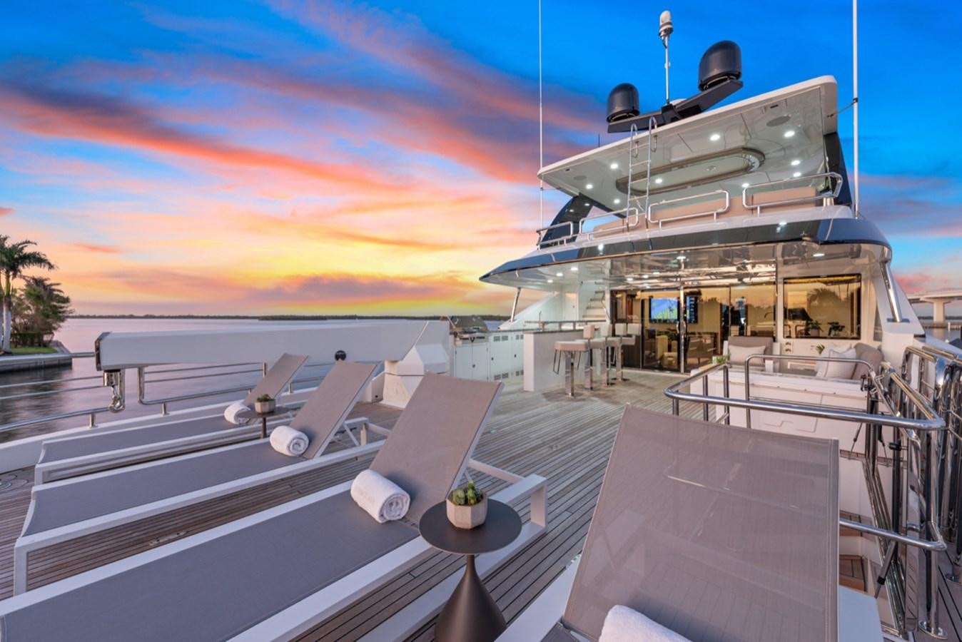 a deck with a satellite dish on it and a sunset in the background aboard EVERGLADE Yacht for Sale