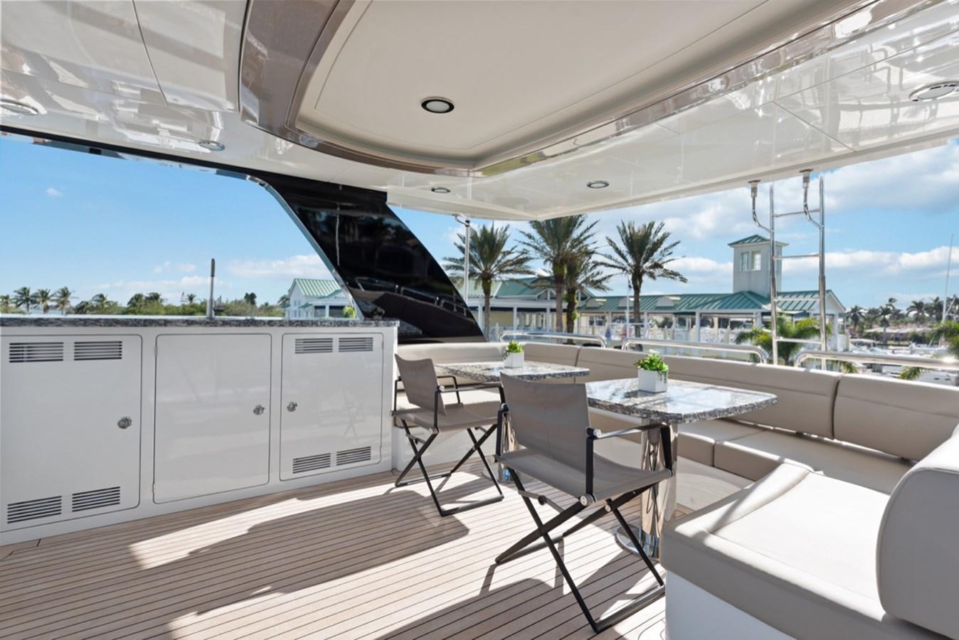 a table and chairs on a deck aboard EVERGLADE Yacht for Sale