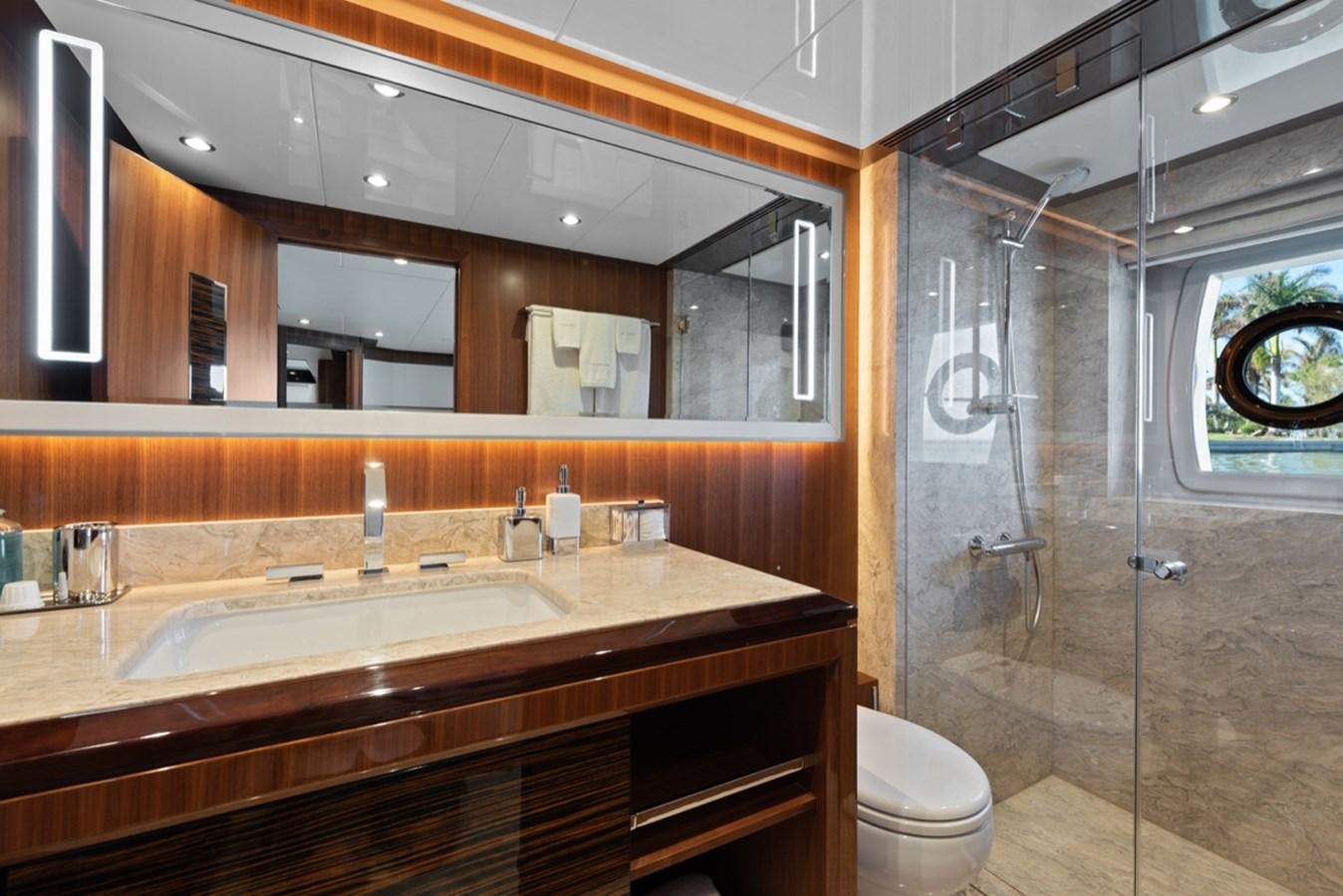a bathroom with a glass shower aboard EVERGLADE Yacht for Sale