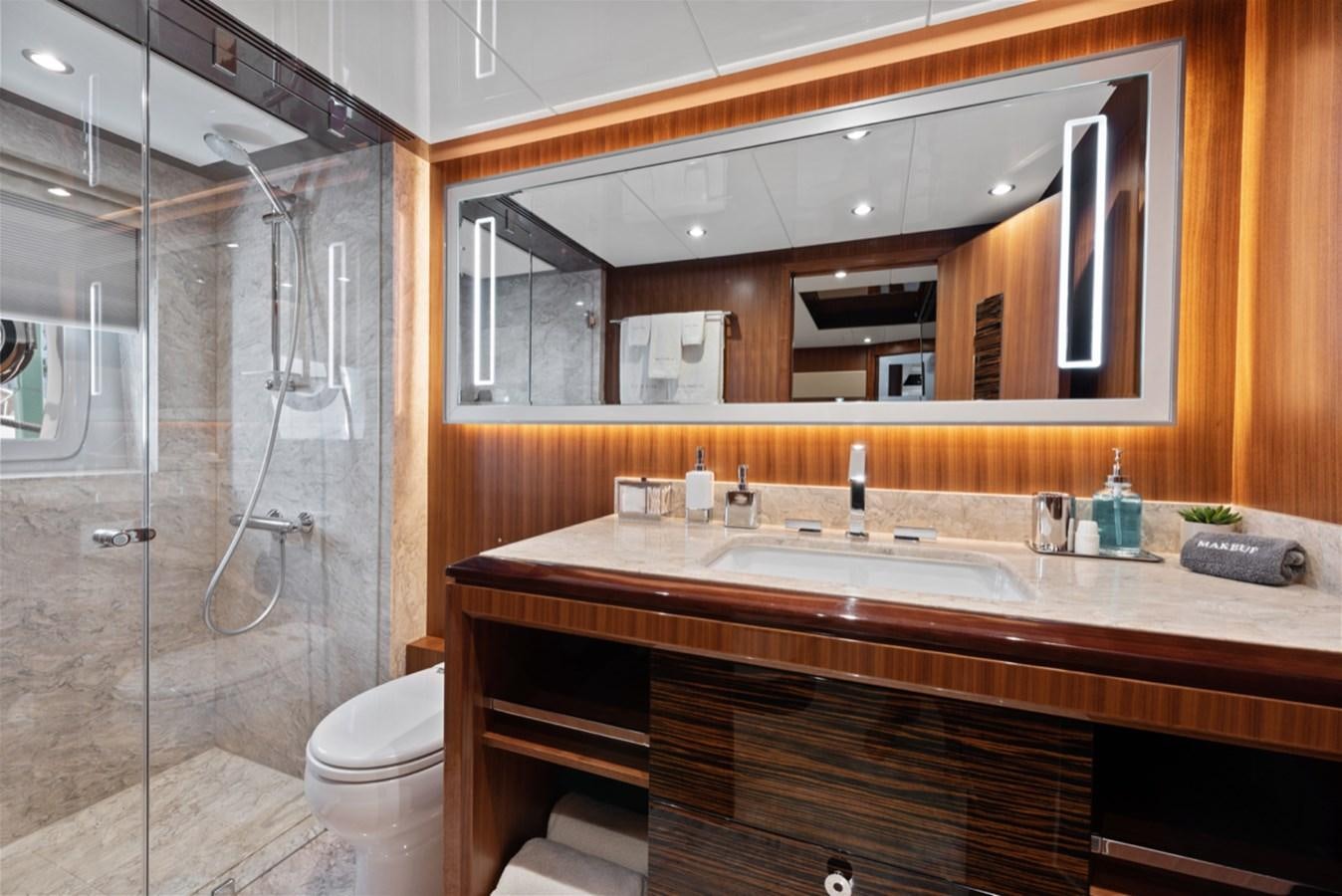 a bathroom with a glass shower aboard EVERGLADE Yacht for Sale