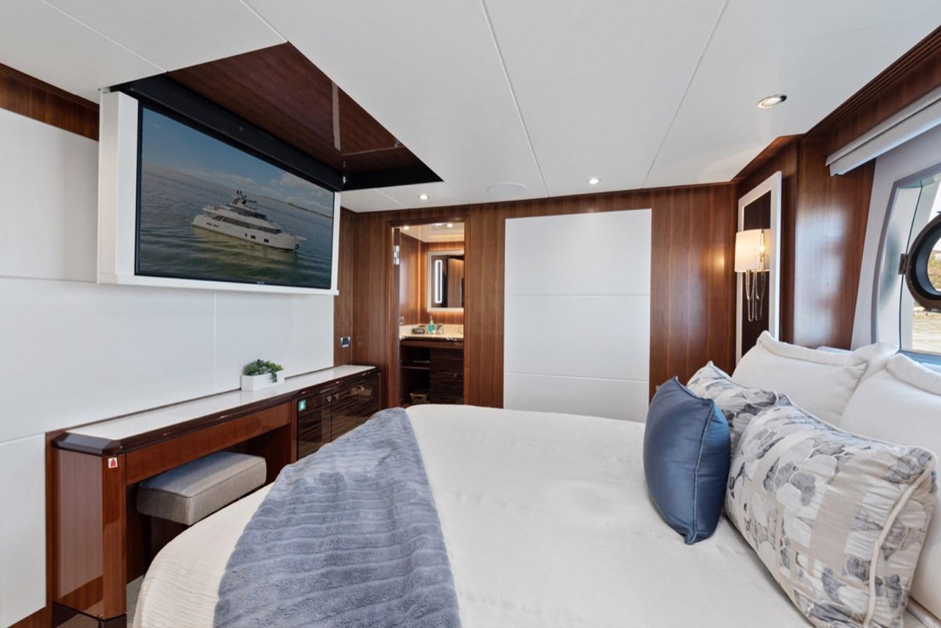 a bed with a white bed aboard EVERGLADE Yacht for Sale