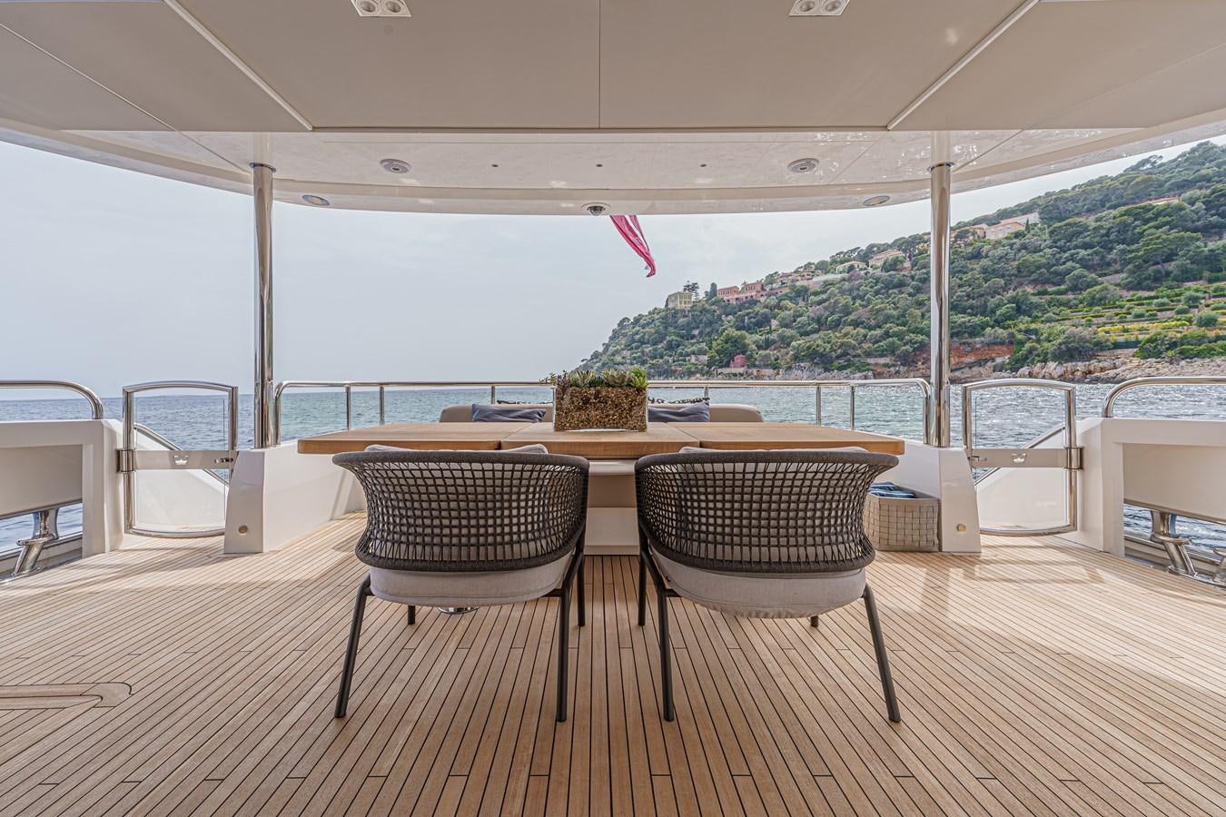 a table and chairs on a patio aboard AVALON Yacht for Sale