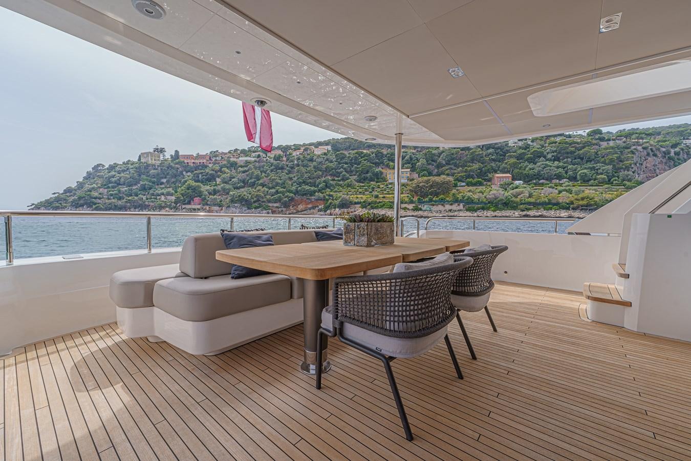 a table and chairs on a deck aboard AVALON Yacht for Sale