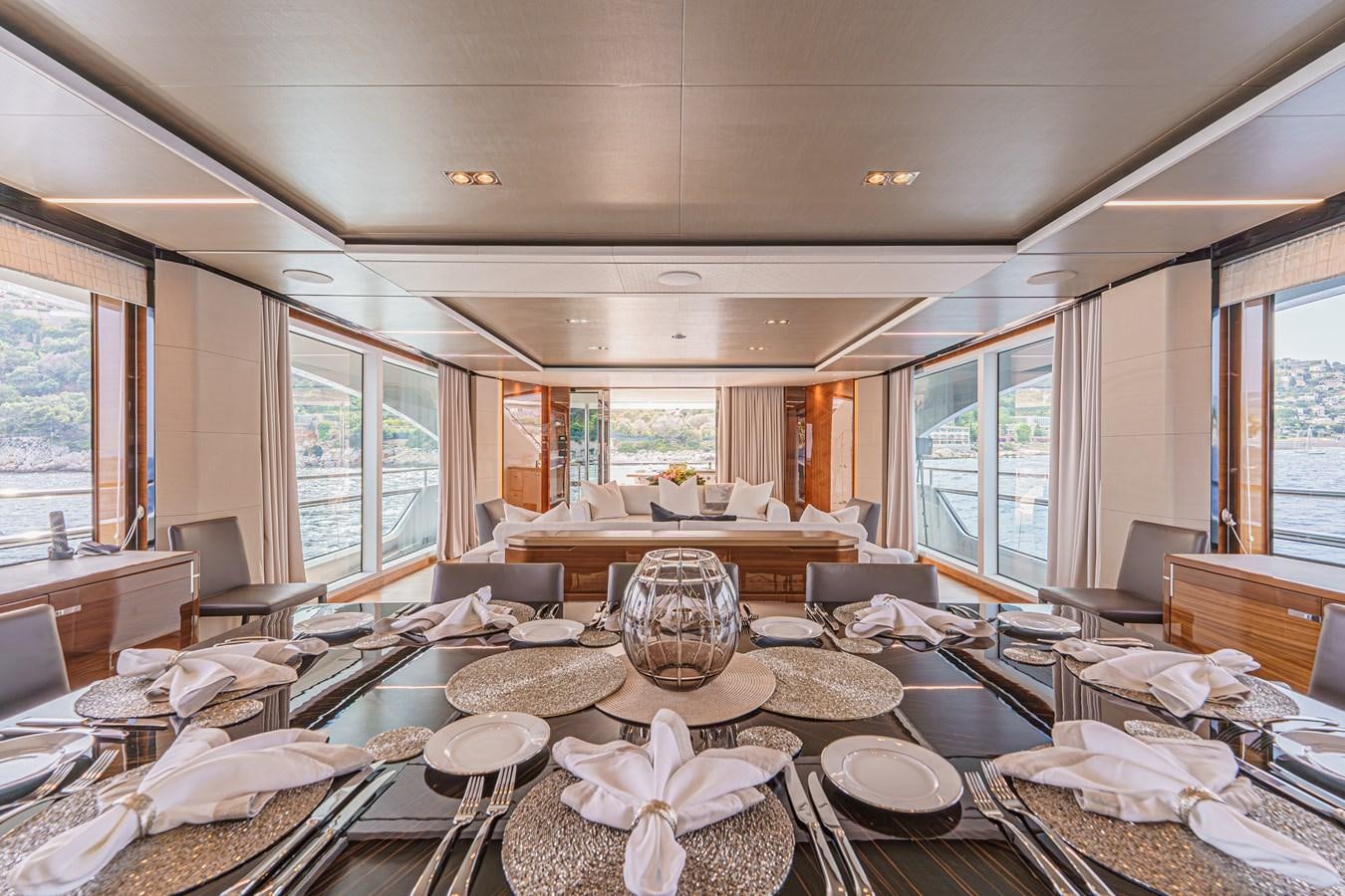 a dining room with a large window aboard AVALON Yacht for Sale