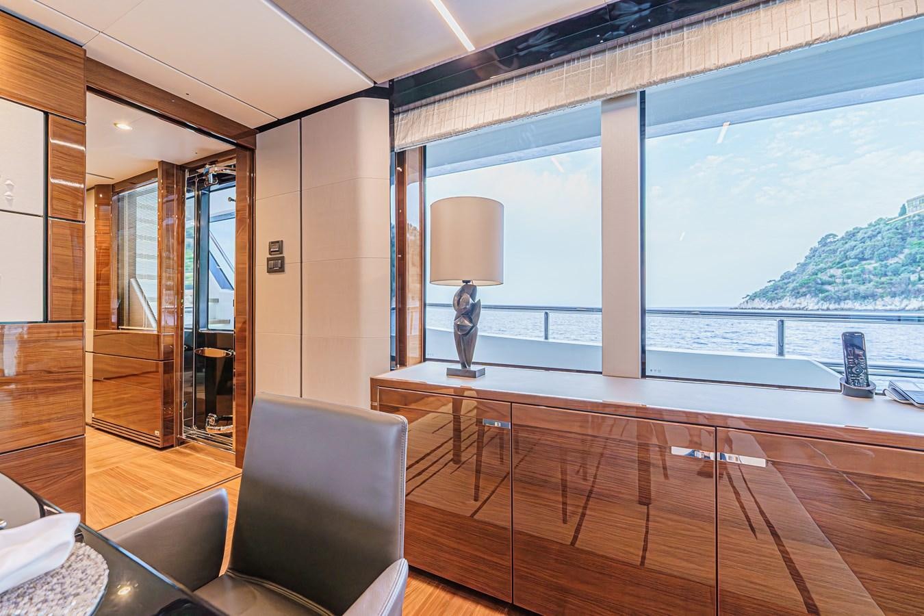 a wood deck with a lamp and a large body of water aboard AVALON Yacht for Sale
