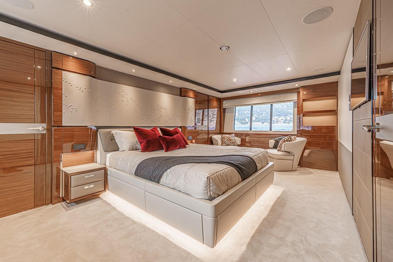 a bedroom with a bed and a desk aboard AVALON Yacht for Sale