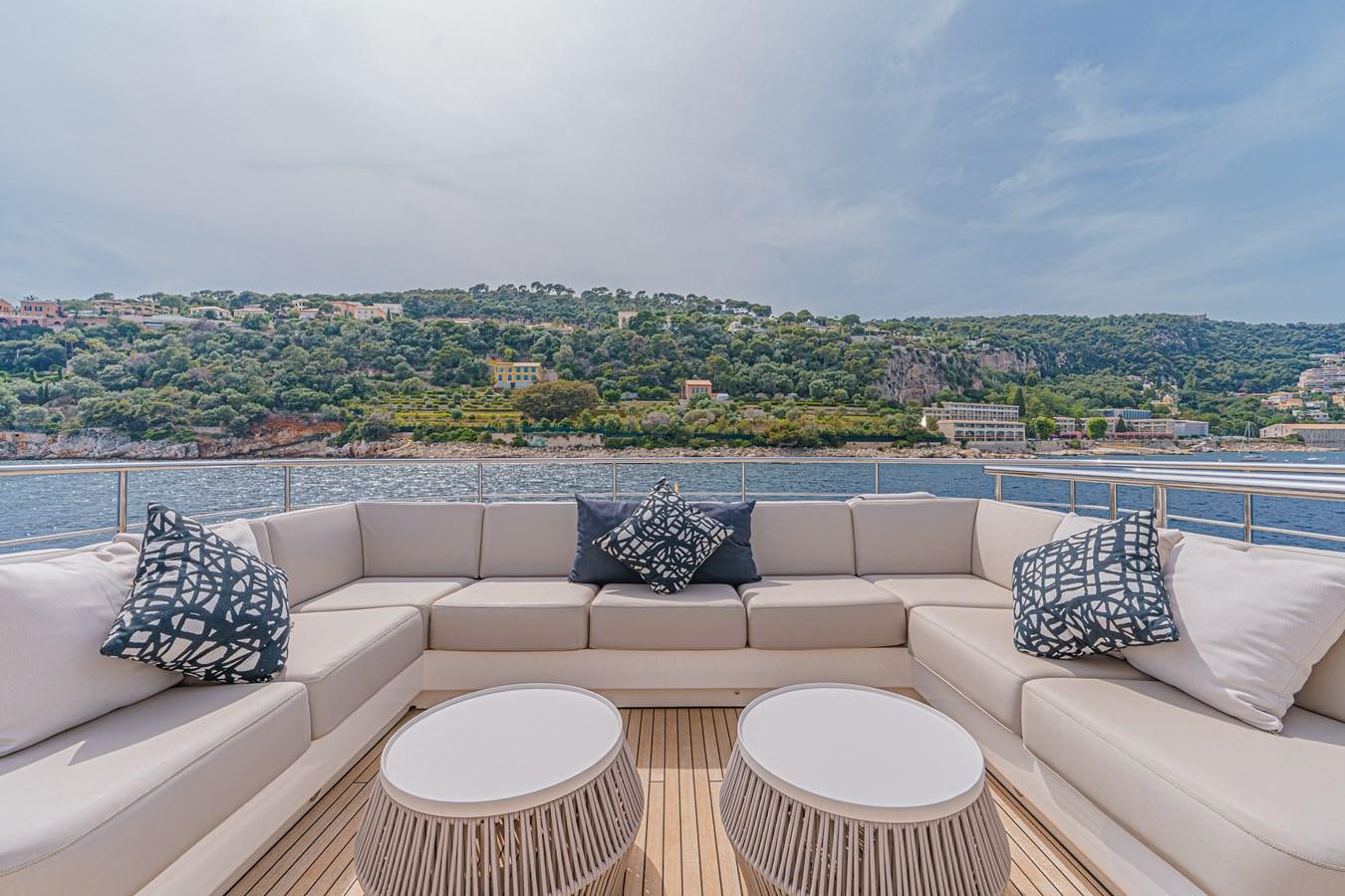 a couch and a table in a room with a view of a city aboard AVALON Yacht for Sale