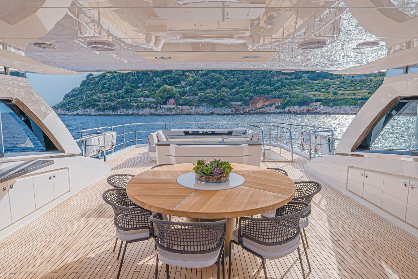 a table on a deck overlooking a body of water aboard AVALON Yacht for Sale