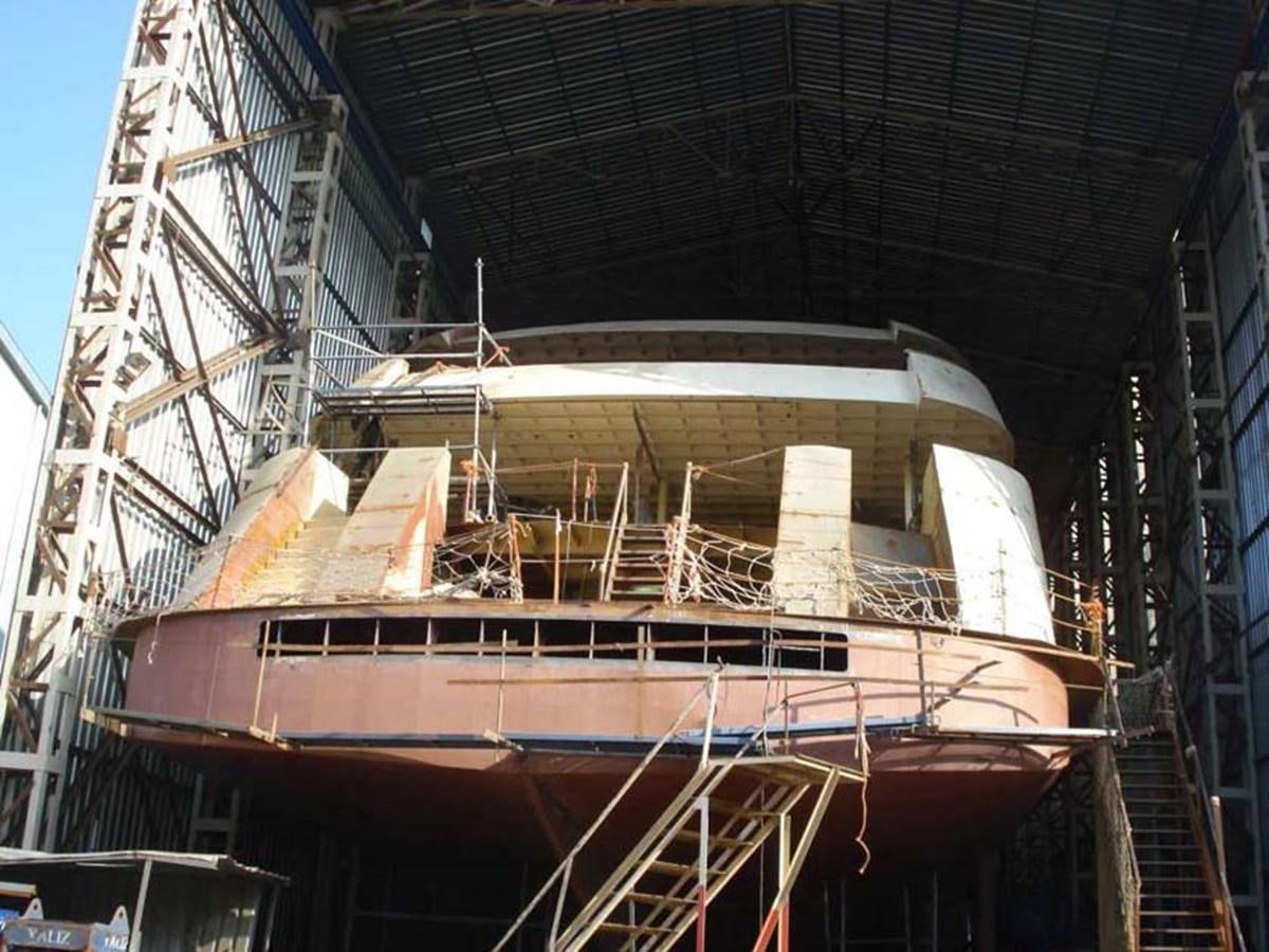 a large white boat under a bridge aboard PHEROUSA Yacht for Sale