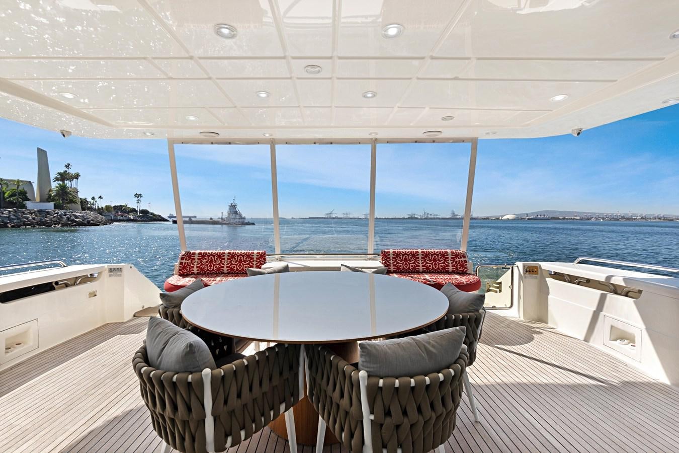 a table and chairs on a deck aboard EL PAVICA Yacht for Sale