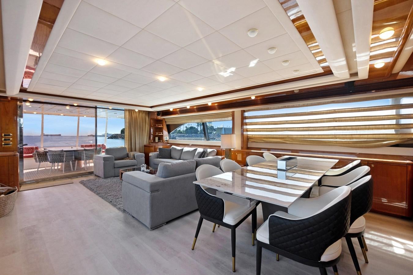 a room with a couch and a table and chairs aboard EL PAVICA Yacht for Sale