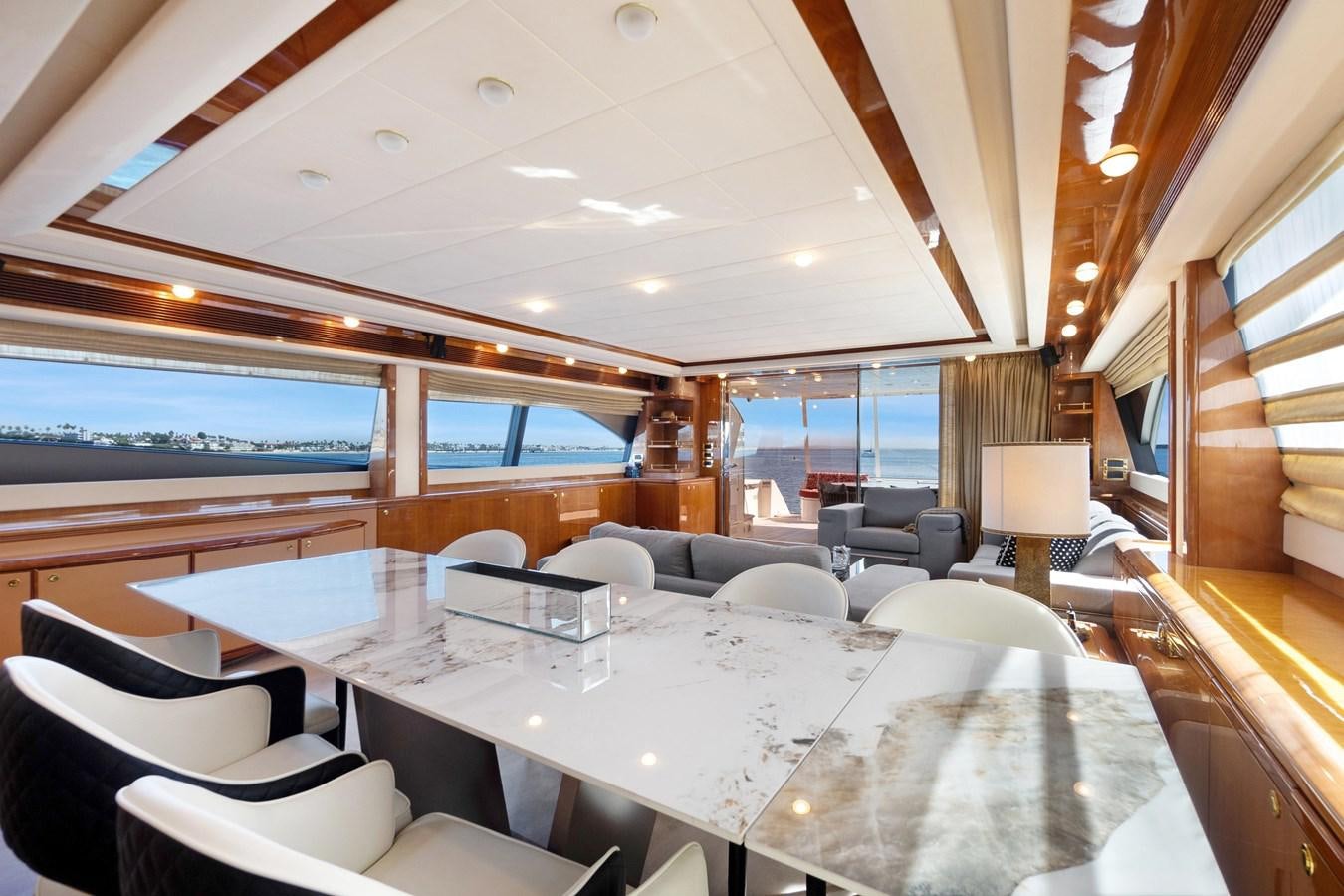 a large room with a large table and chairs aboard EL PAVICA Yacht for Sale
