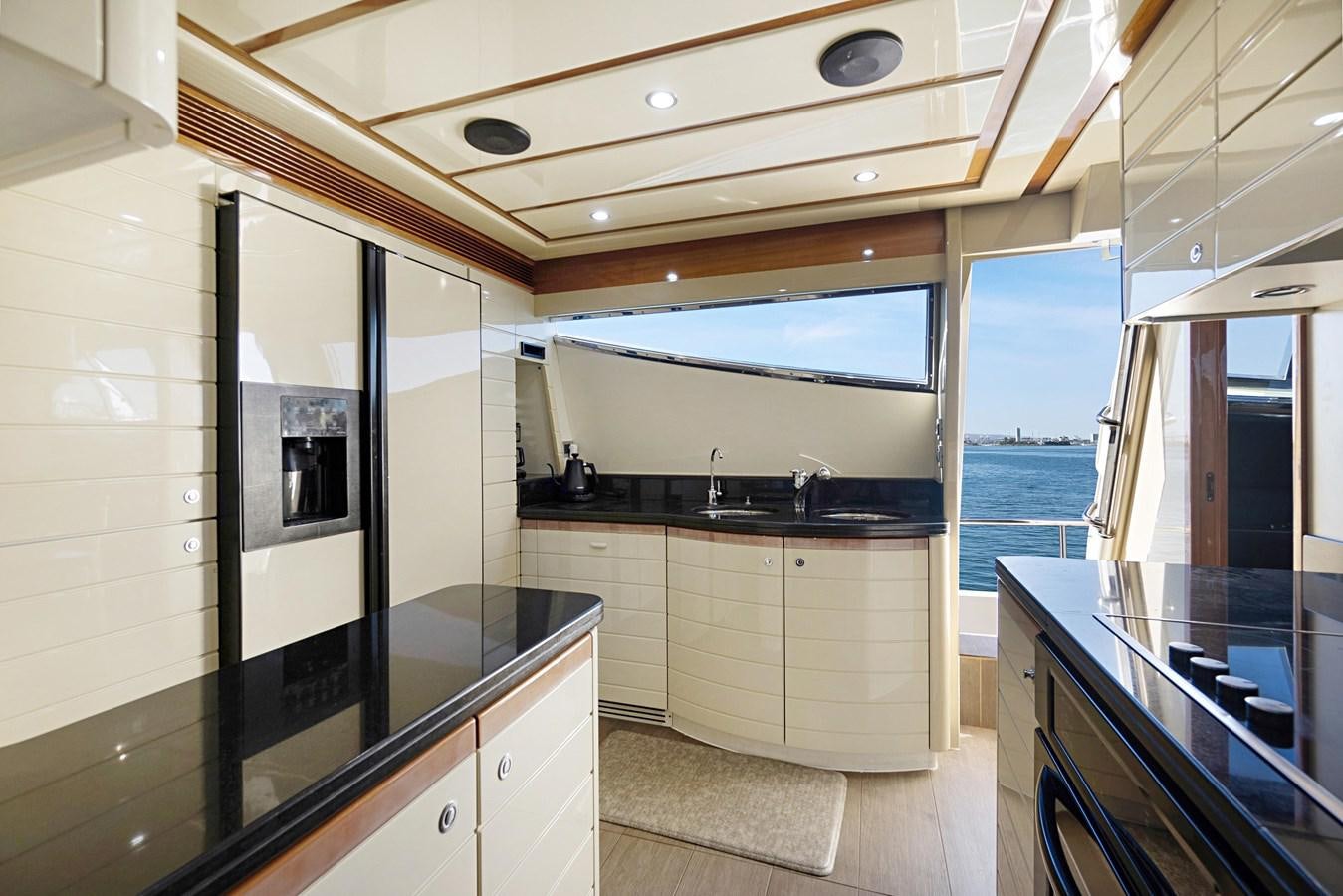 a kitchen with a large window aboard EL PAVICA Yacht for Sale