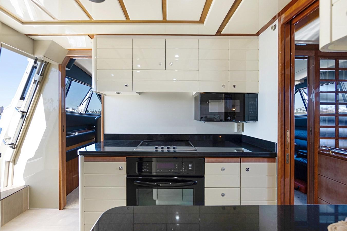 a kitchen with white cabinets aboard EL PAVICA Yacht for Sale