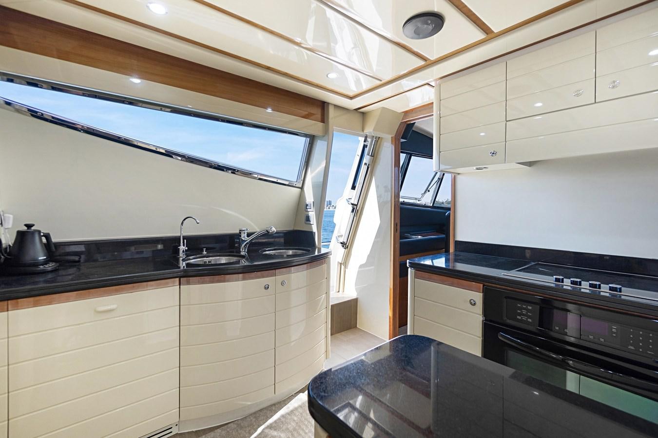 a kitchen with white cabinets aboard EL PAVICA Yacht for Sale