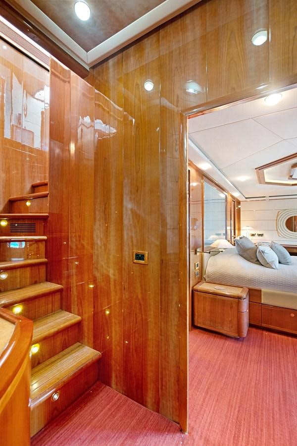 a room with a bed and a wood door aboard EL PAVICA Yacht for Sale