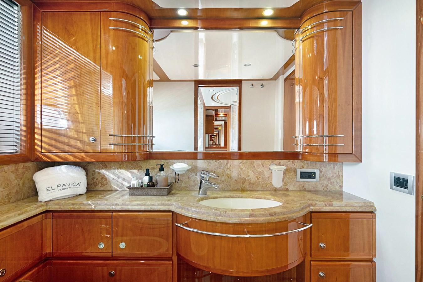 a bathroom with wooden cabinets aboard EL PAVICA Yacht for Sale