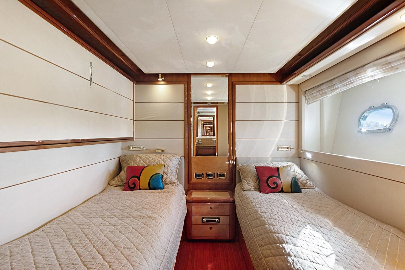 a bedroom with a bed and a mirror aboard EL PAVICA Yacht for Sale