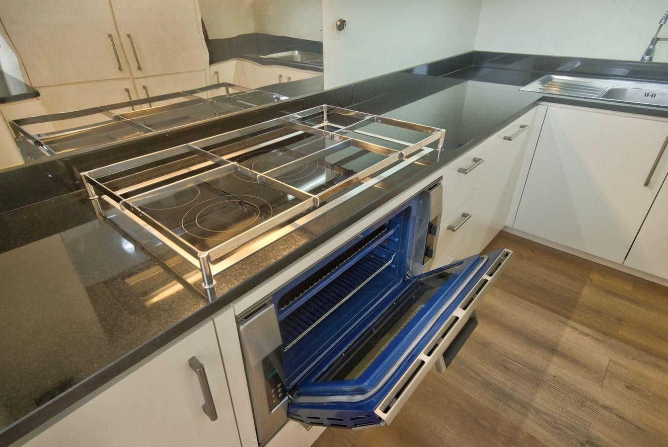 a kitchen with a stove and oven aboard LUISAMAY Yacht for Sale