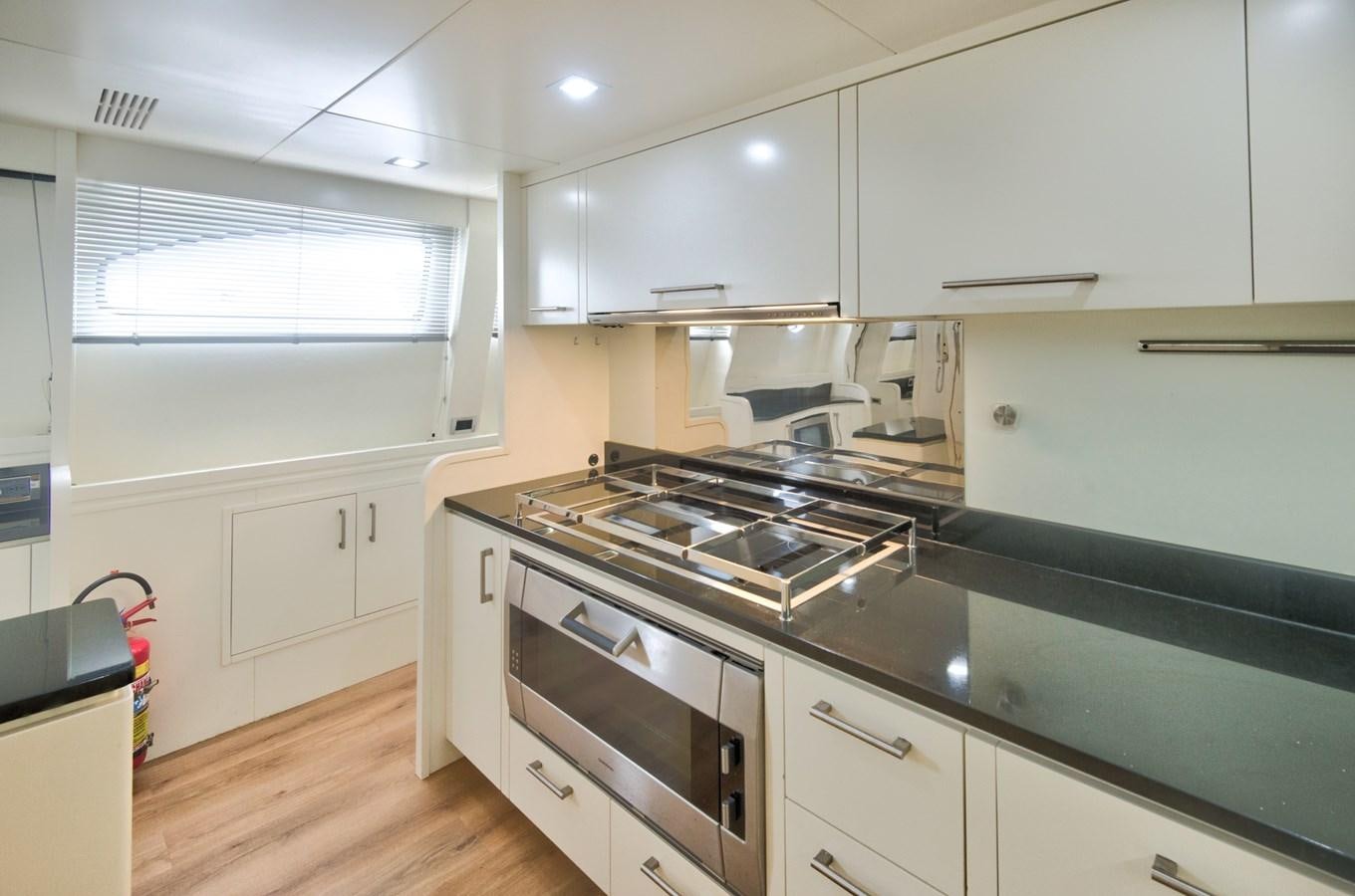 a kitchen with white cabinets aboard LUISAMAY Yacht for Sale