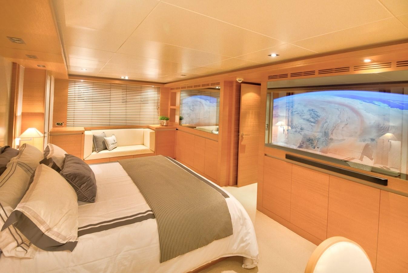 a room with a bed and a tv on the wall aboard LUISAMAY Yacht for Sale