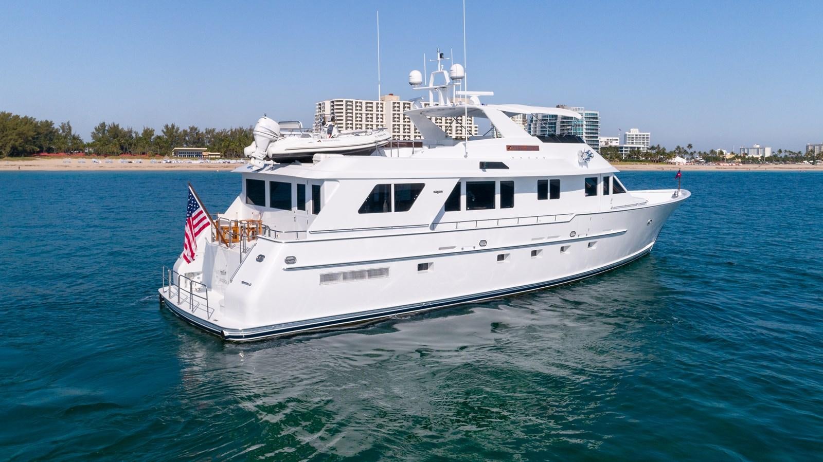 a large white boat on the water aboard WELL DONE Yacht for Sale