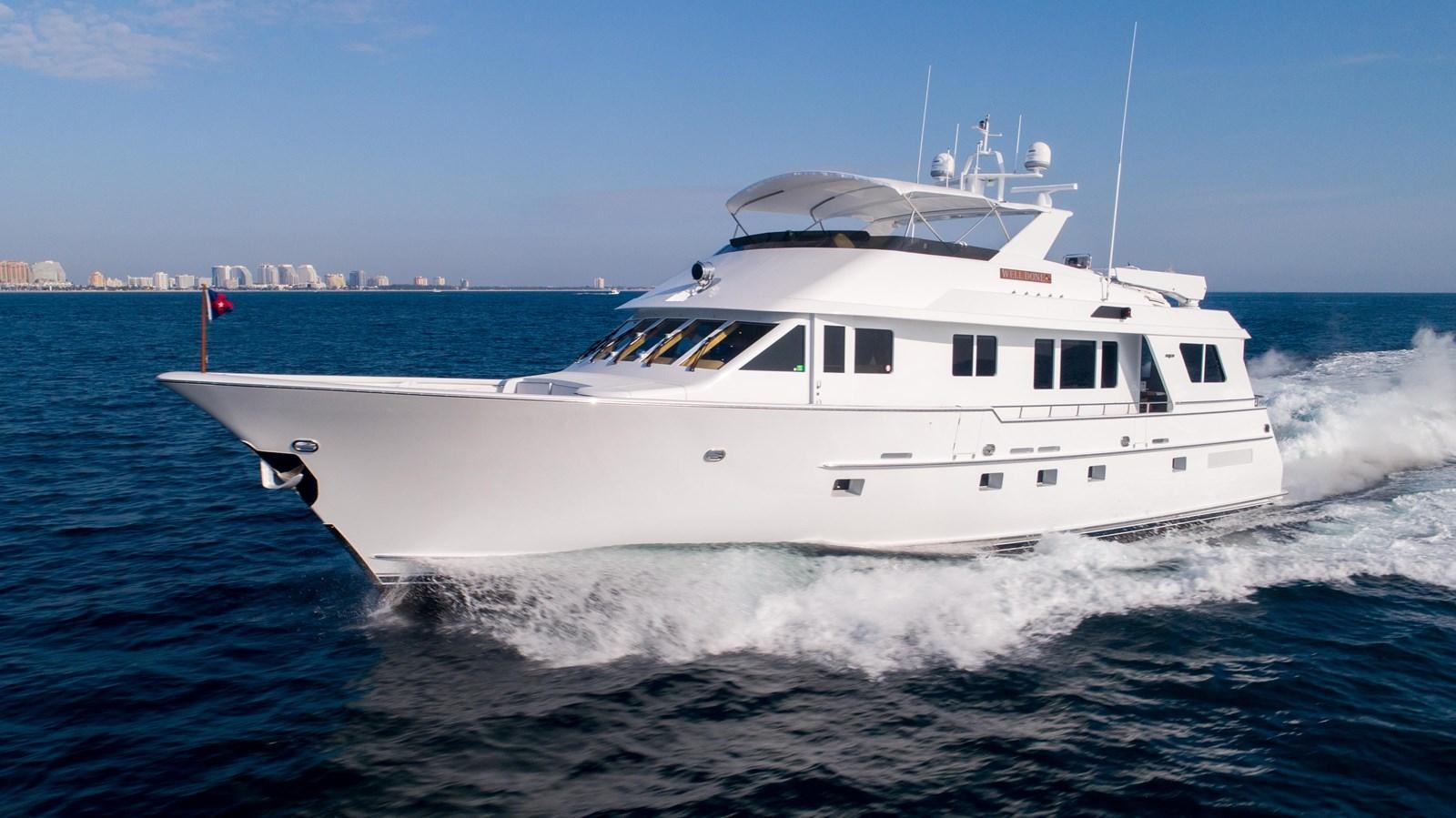 a white yacht on the water aboard WELL DONE Yacht for Sale