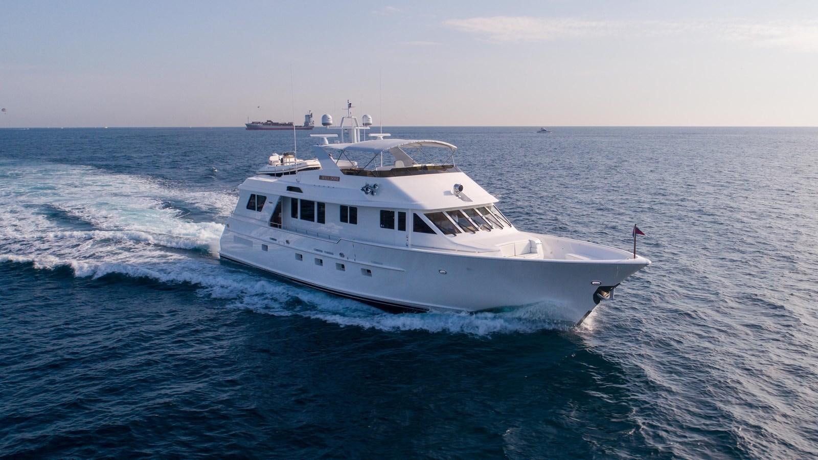 a white boat in the water aboard WELL DONE Yacht for Sale