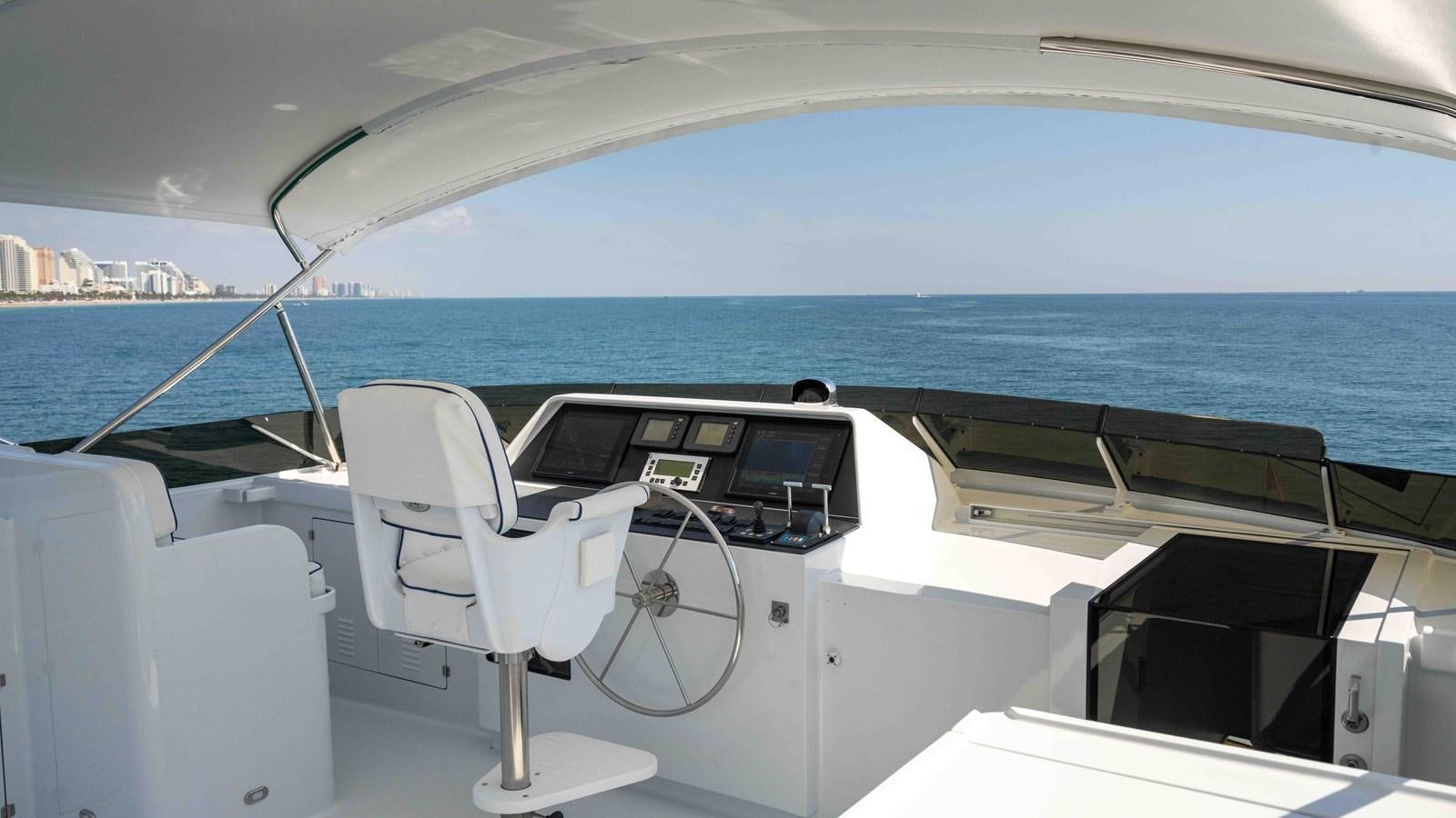 a boat with a chair on the deck aboard WELL DONE Yacht for Sale