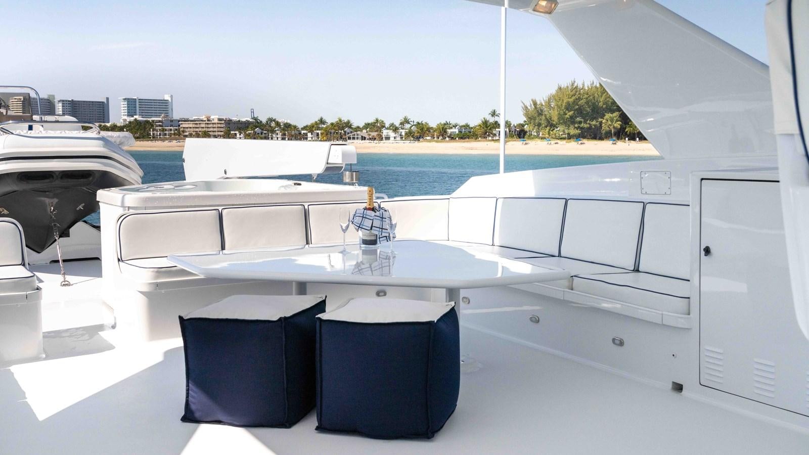 a table with chairs on it aboard WELL DONE Yacht for Sale