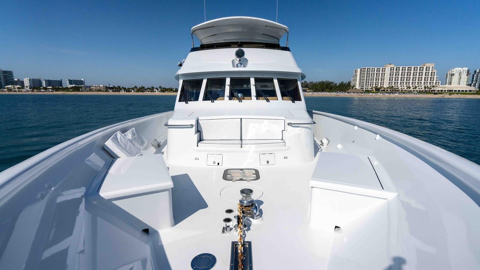 a white boat on a body of water aboard WELL DONE Yacht for Sale