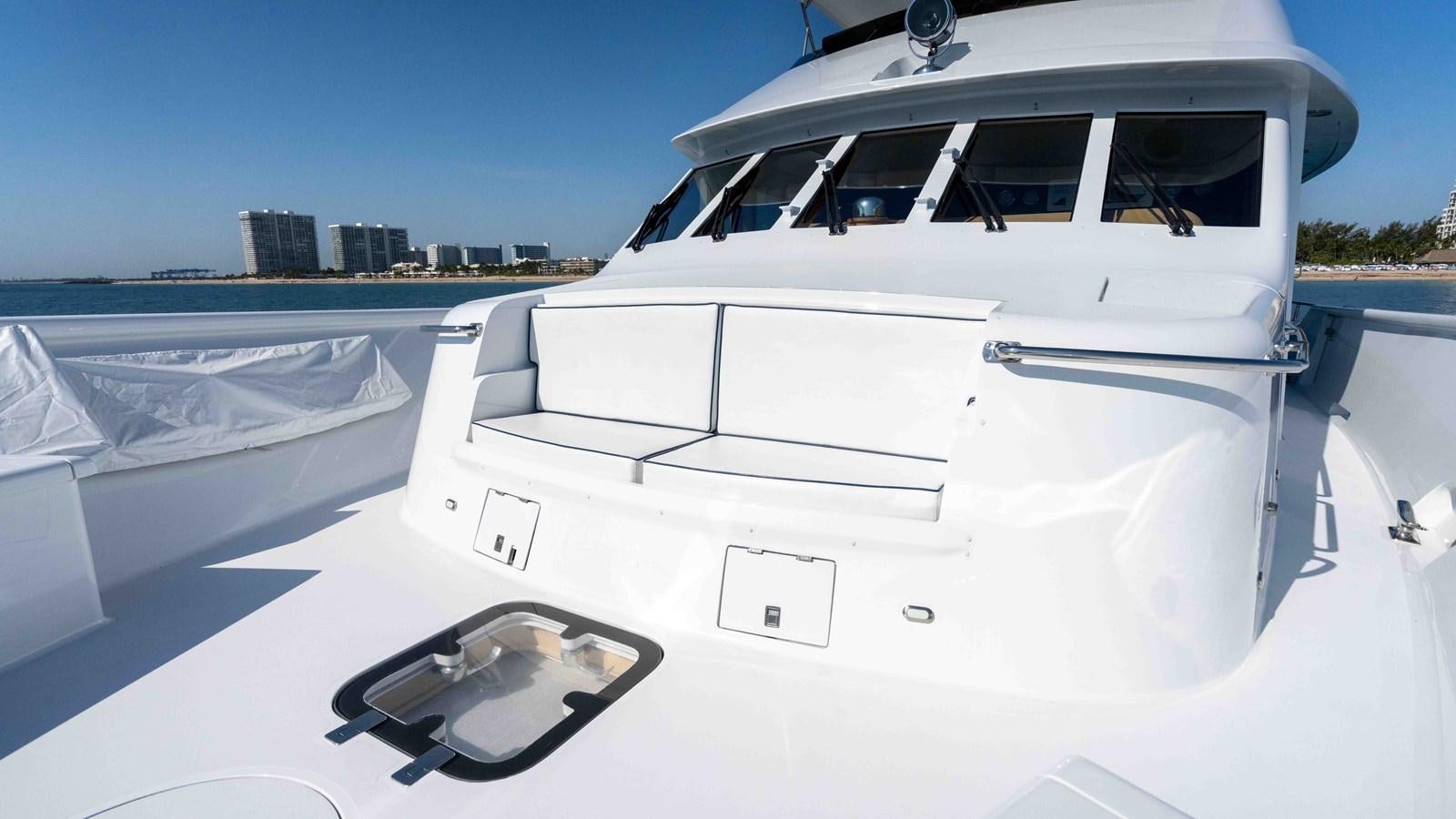 a white yacht on a beach aboard WELL DONE Yacht for Sale