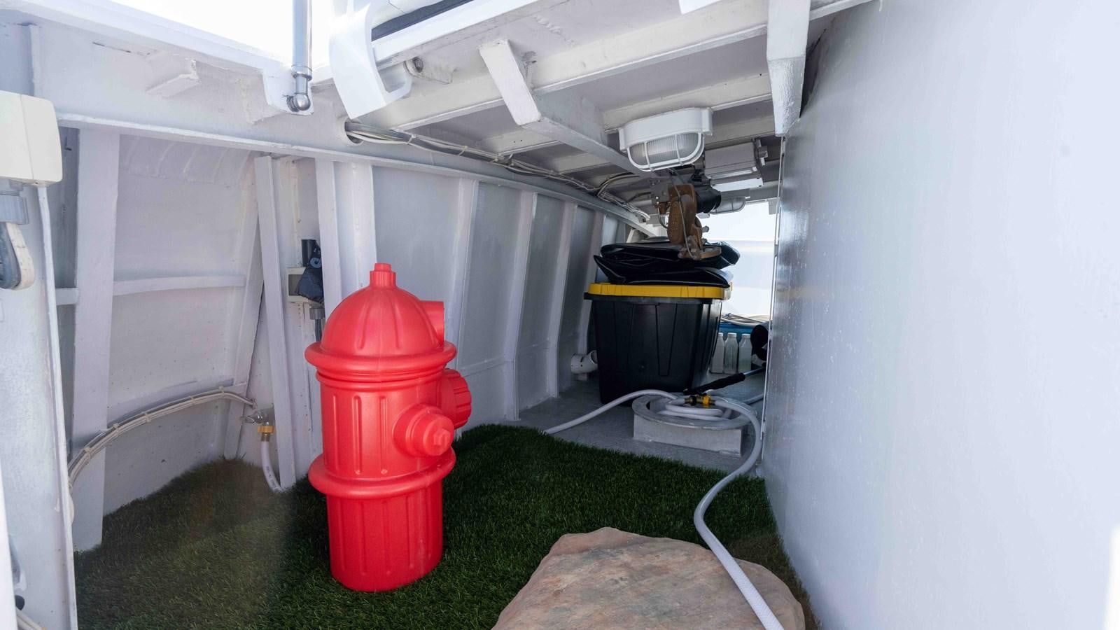a red fire hydrant in a room aboard WELL DONE Yacht for Sale