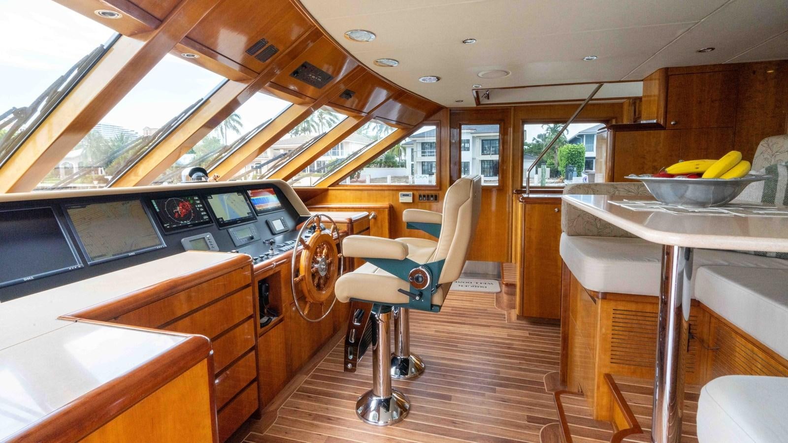 a room with a table and chairs aboard WELL DONE Yacht for Sale