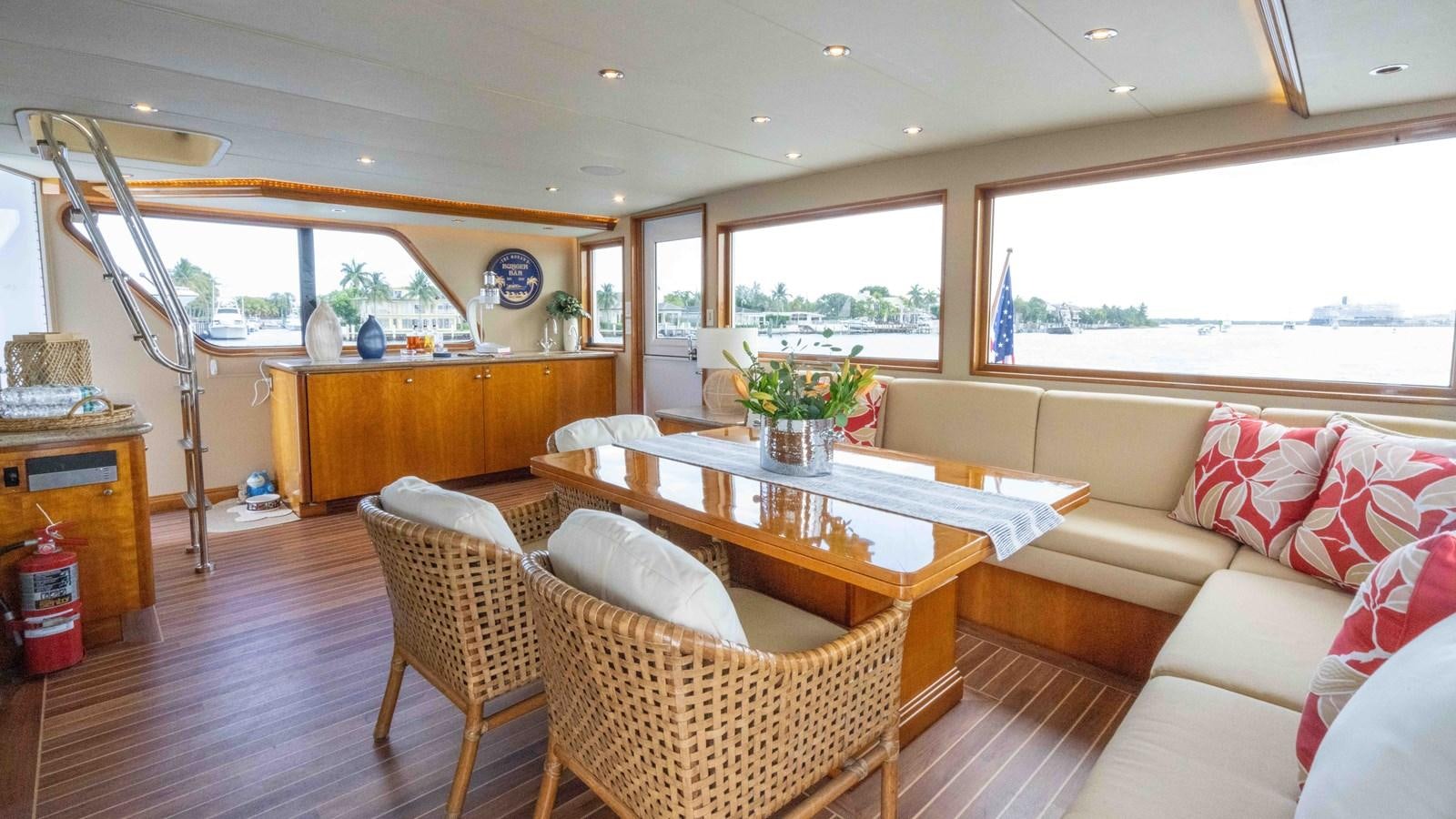 a living room with a table and chairs aboard WELL DONE Yacht for Sale