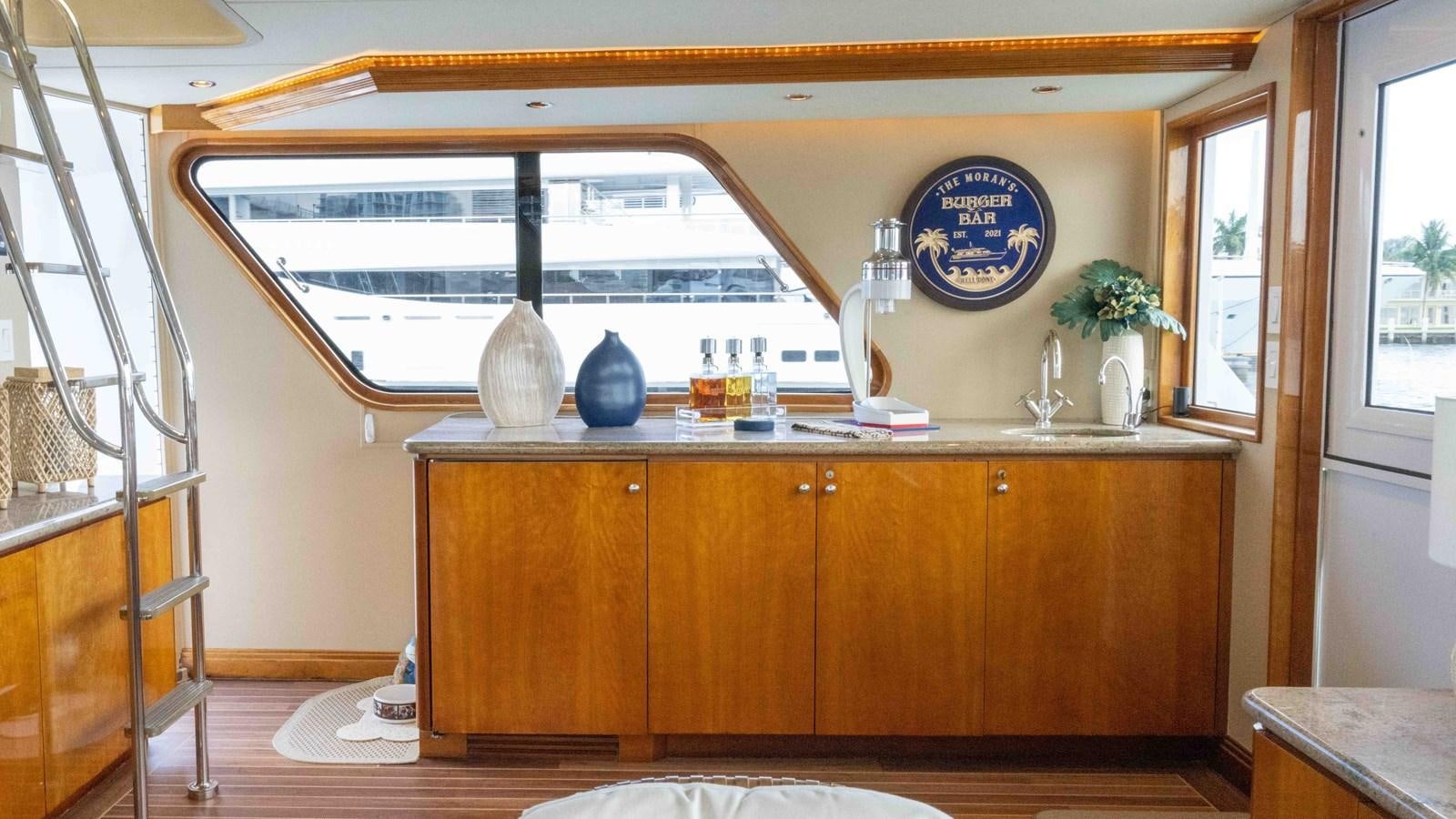 a kitchen with a glass window aboard WELL DONE Yacht for Sale