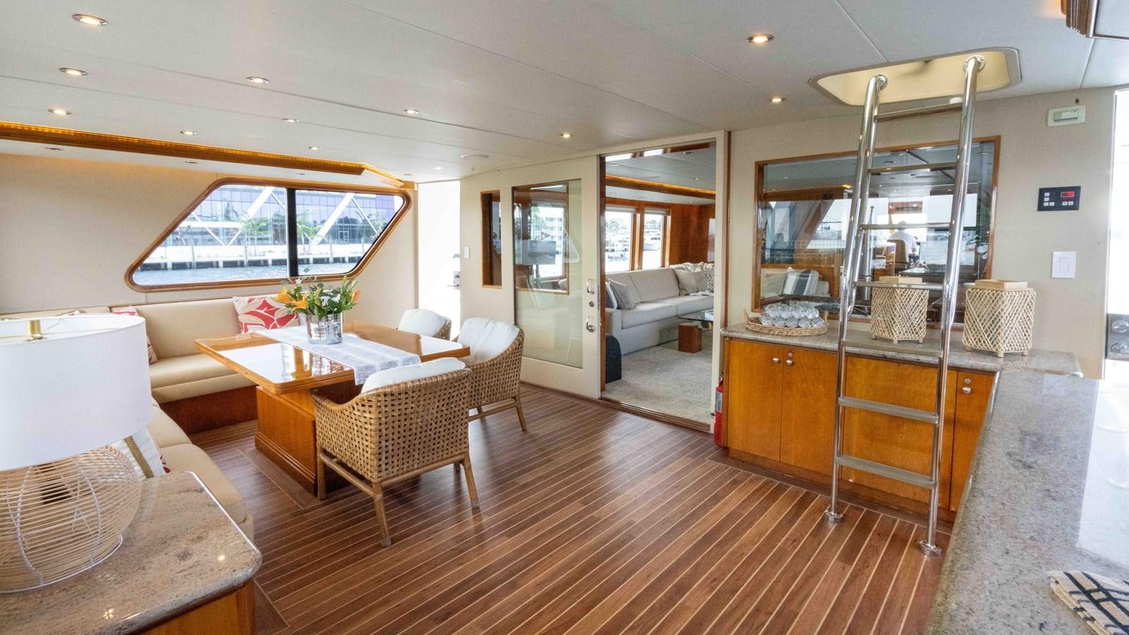 a living room with a table and chairs aboard WELL DONE Yacht for Sale