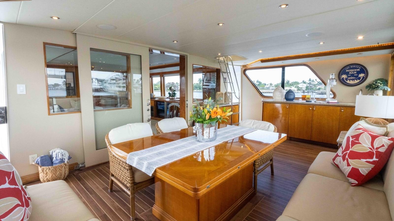 a living room with a table and chairs aboard WELL DONE Yacht for Sale