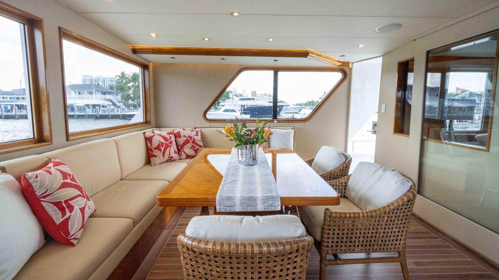 a living room with a table and chairs aboard WELL DONE Yacht for Sale