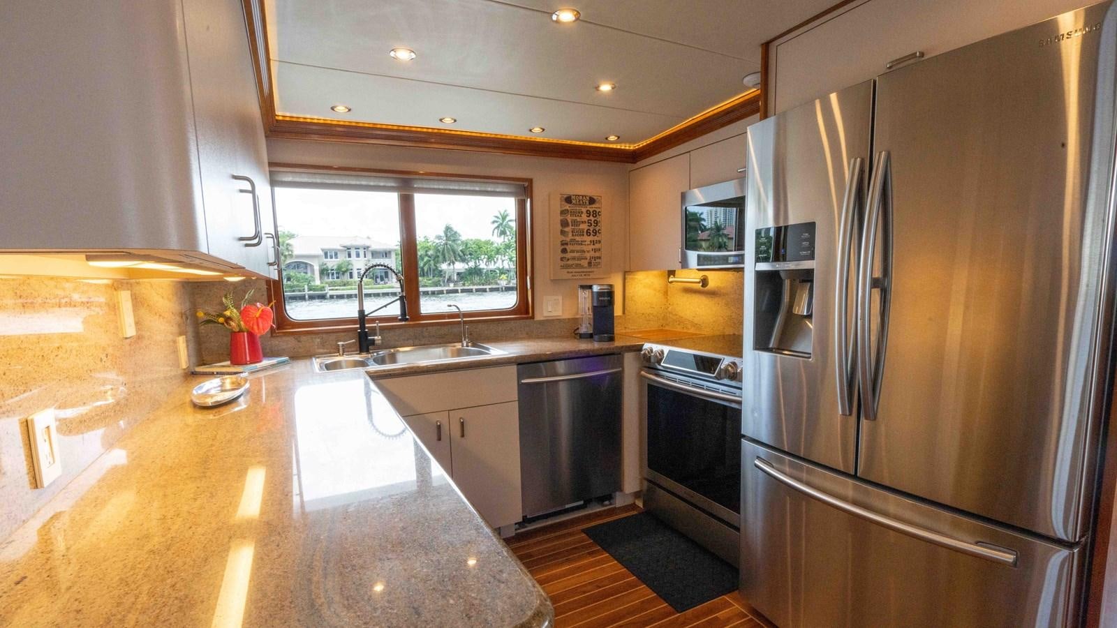 a kitchen with stainless steel appliances aboard WELL DONE Yacht for Sale