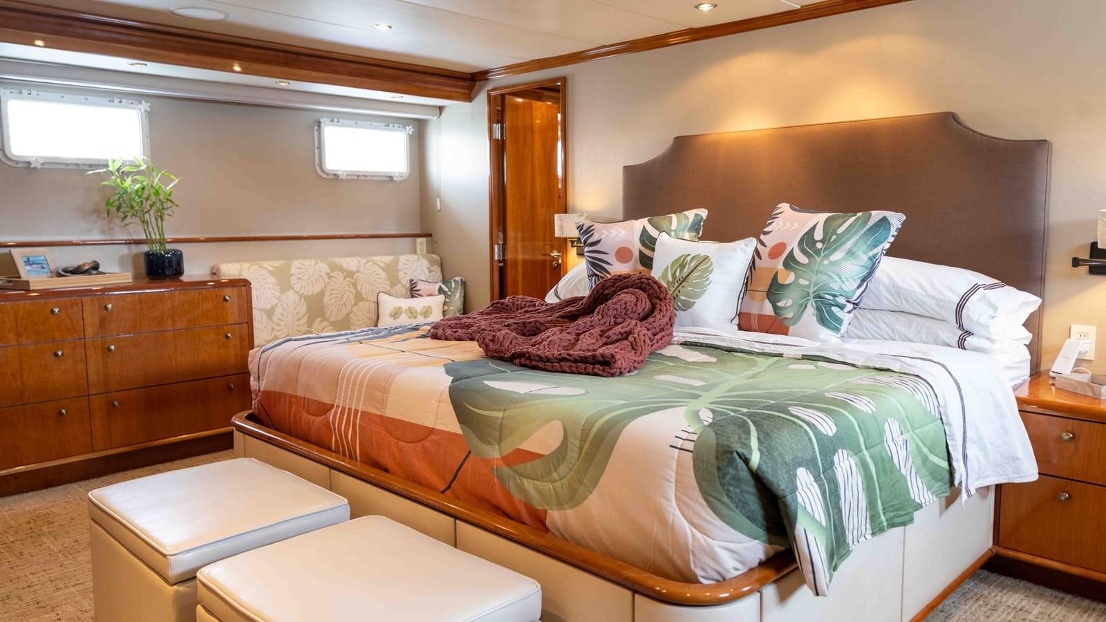 a bed with green sheets aboard WELL DONE Yacht for Sale