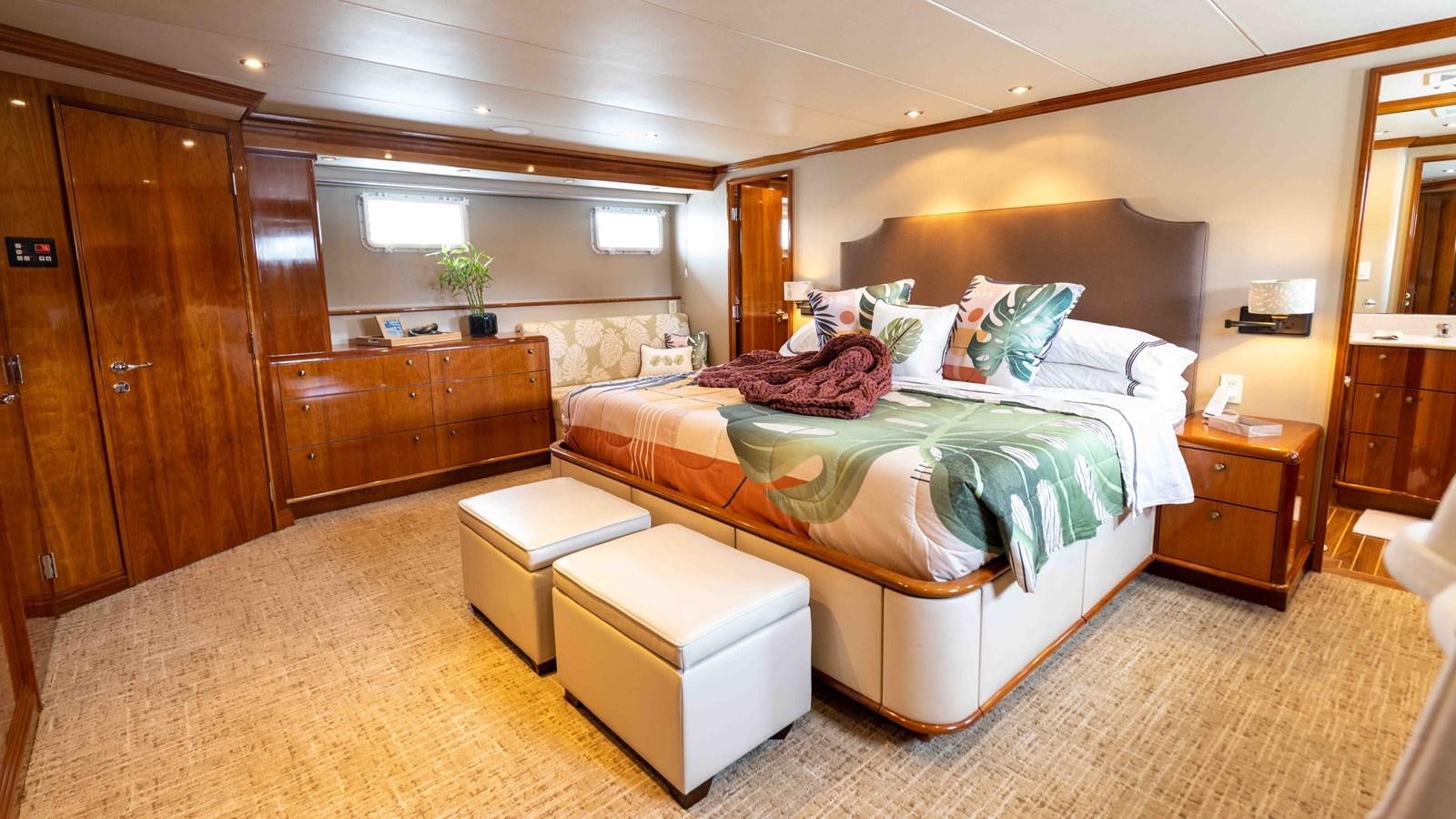 a large bedroom with a bed aboard WELL DONE Yacht for Sale