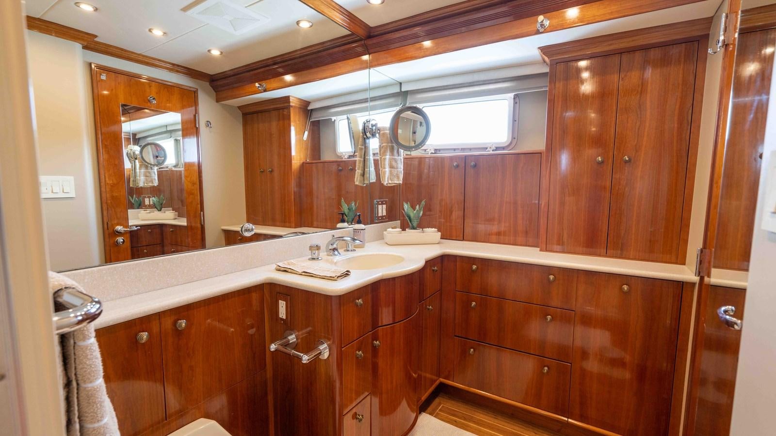 a bathroom with wooden cabinets aboard WELL DONE Yacht for Sale
