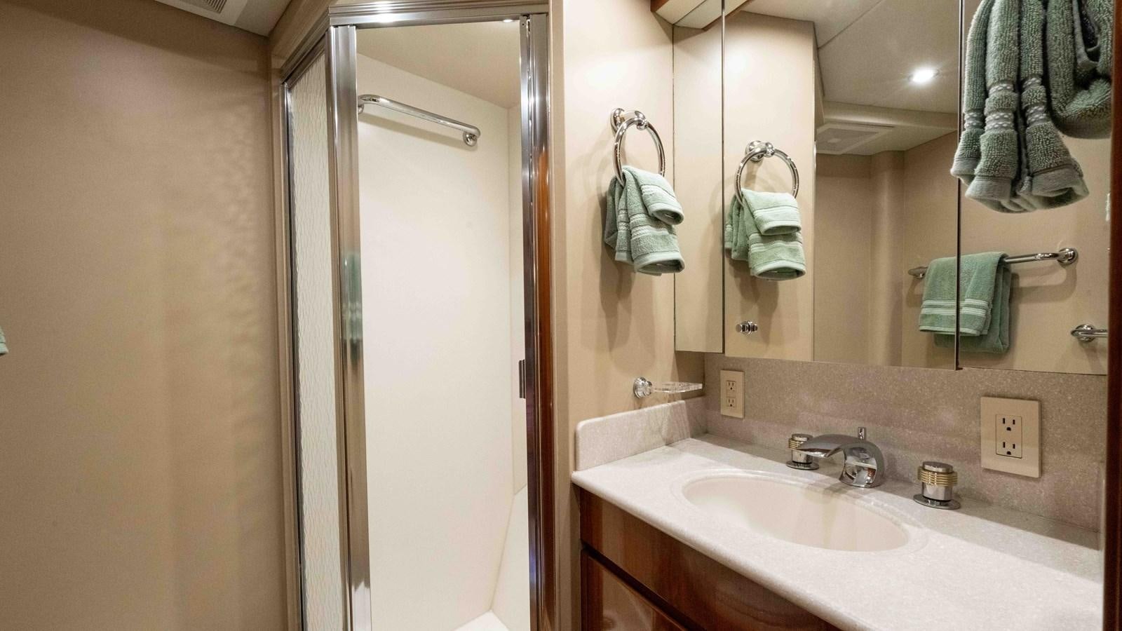 a bathroom with a sink and a mirror aboard WELL DONE Yacht for Sale