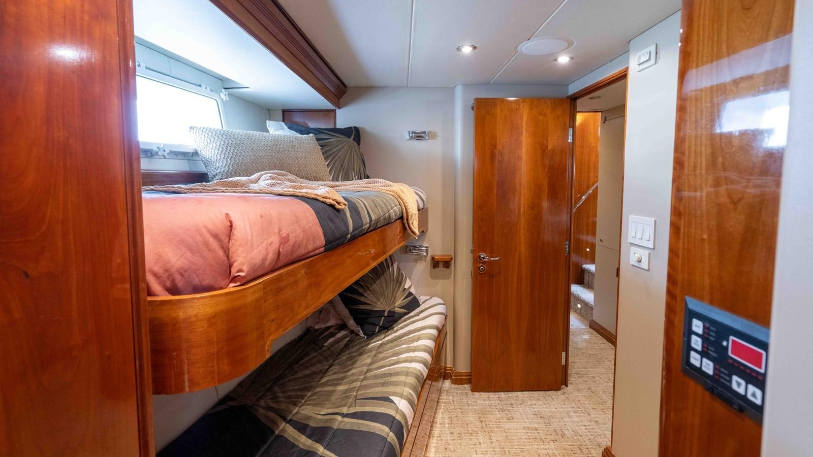 a bedroom with a bed and a television aboard WELL DONE Yacht for Sale
