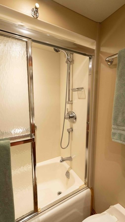 a shower with a glass door aboard WELL DONE Yacht for Sale